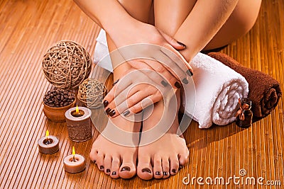 Brown manicure and pedicure on the bamboo Stock Photo