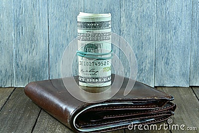 Brown mens wallet and dollars Stock Photo