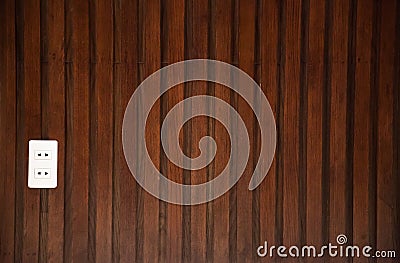 Brown natural textured wood panel wall boarding background with white Asian electricity socket. Interior decoration architectural Stock Photo