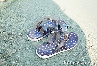 Brown pair of sandals on the beach Stock Photo