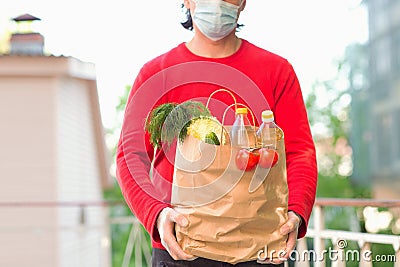 Brown paper bag with vegetables, in the hands of a man Stock Photo