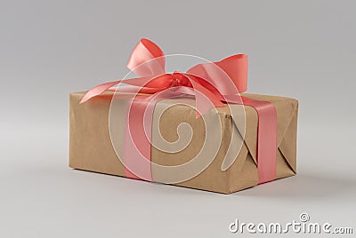 Brown paper gift box with silk rose ribbon on gray background Stock Photo