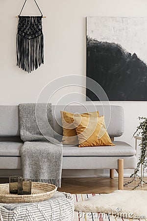 Brown pillows and blanket on grey sofa in natural living. Real photo Stock Photo