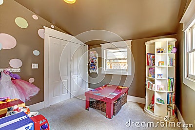 Brown play room kids girl interior with toys. Stock Photo