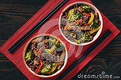 Brown rice noodles with meat and vegetables, oriental style cuisine. Stock Photo