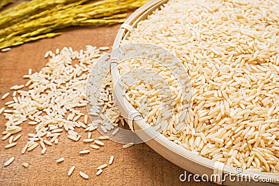 Brown rice on wicker basket Stock Photo