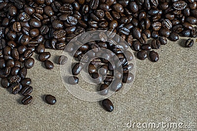 Brown roasted coffee beans, seed on woodenbackground Stock Photo