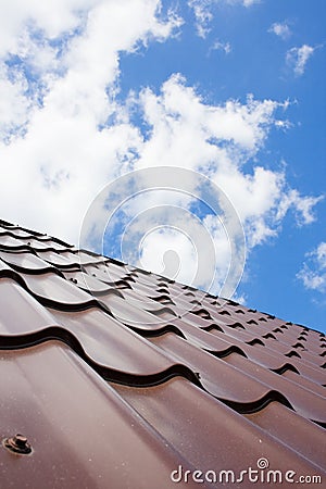 Brown roof of metal roofing on the sky background Stock Photo