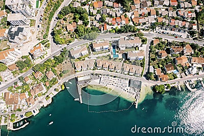 Brown roofs of the Huma Kotor Bay Hotel with a private beach. Dobrota, Montenegro. Drone Stock Photo