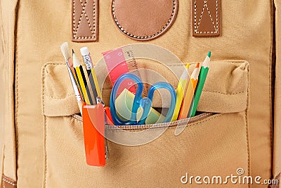 Brown school backpack full of various stationery. Close-up shot. Stock Photo
