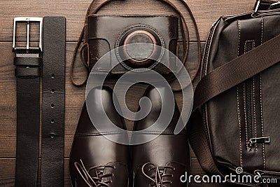 Brown shoes, belt, bag and film camera Stock Photo