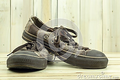 Brown sneakers on the wooden background. Stock Photo