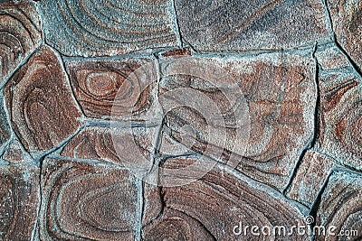 Brown stone background texture, free space. Stone tile floor paving fragment. Stone wall surface with cement. Stock Photo