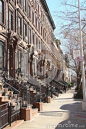 Brown stone row houses with high stoops in Harlem Stock Photo