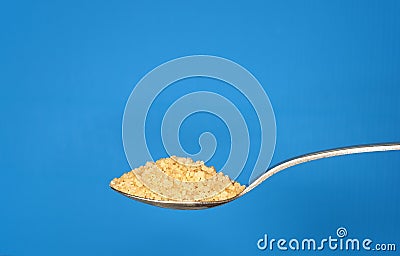 Brown sugar on metallic teaspoon Stock Photo