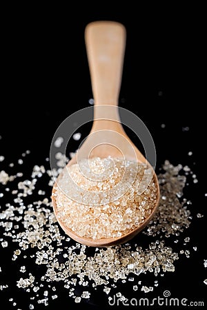 Brown sugar in wood spoon on black background.Components of The Stock Photo