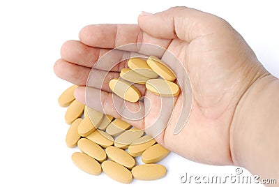 Brown tablets in hand Stock Photo