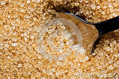 Brown, unrefined sugar and a silver spoon in it Stock Photo