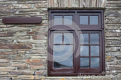 Brown window frame on a brick wall Stock Photo