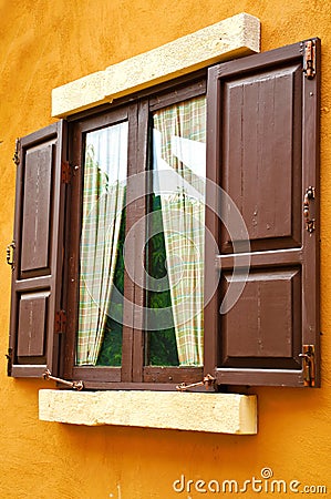 Brown window on yellow wall Stock Photo