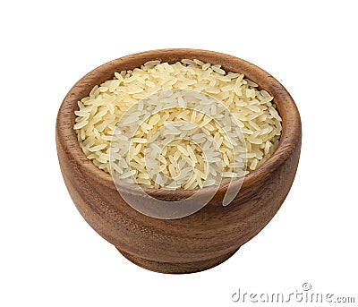 Brown wooden bowl with dry uncooked parboiled rice grain Stock Photo