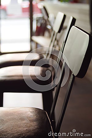 Brown wooden chairs arranged in rows in the office Stock Photo