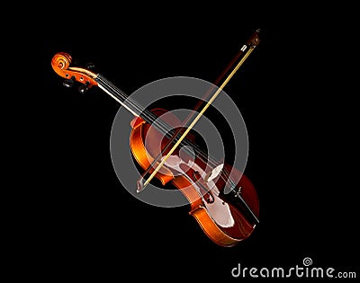 Brown wooden fiddle or violin, classic musical instrument, with bow isolated over black background Stock Photo