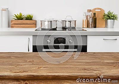 Brown wooden table on defocused pastel color kitchen interior background Stock Photo