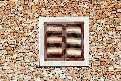 Brown wooden window in masonry wall Stock Photo