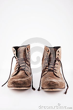 Brown worn vintage boots with untied laces in studio Stock Photo