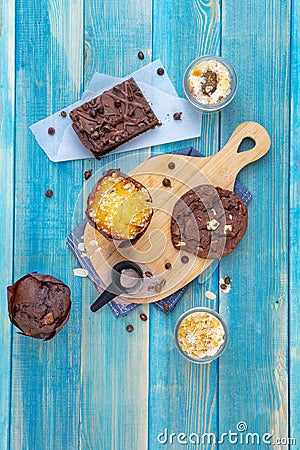 Brownie and Chocolate Cookie with Chocolate and Vanilla Desserts in Small Glasses Next to Chocolate Powder Spoon, Homemade Bakery Stock Photo