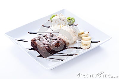 Brownie and ice cream with whipping cream and banana slices Stock Photo