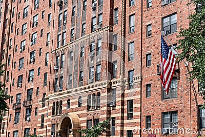 brownstone building architecture of new york. american flag on brick brownstone building. architectural exterior and Stock Photo