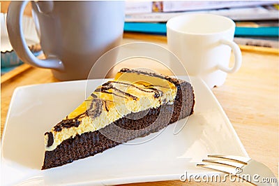 Browny cheese cake on white dish with coffee cup and relaxing ma Stock Photo