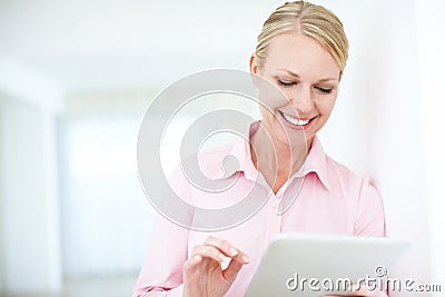 Browsing through the business headlines. An attractive young businesswoman using a digital tablet. Stock Photo