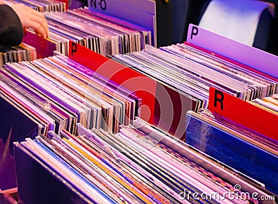 Browsing through old vinyl records in music shop. Music background. Stock Photo