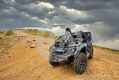 BRP Can-Am Outlander quad bike in foggy Caucasus mountains. ATV and SSV travel adventure and nature exploration concept Editorial Stock Photo