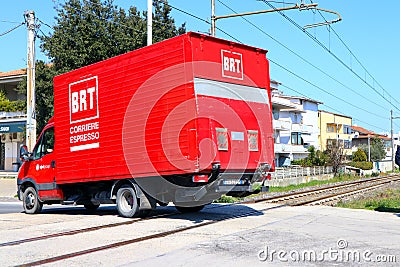 BRT Bartolini Express Courier truck in movment on railroad intersection. BRT Bartolini is an Italian express transportation Editorial Stock Photo
