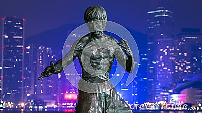 Bruce Lee monument timelapse hyperlapse in the night at the Avenue of stars, in Hong Kong. Editorial Stock Photo