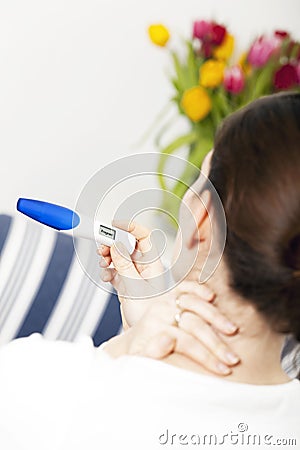 Bruentte woman with pregnancy test Stock Photo