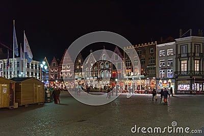 People on the large Market Square Markt in the centre of Bruges, night scene Editorial Stock Photo