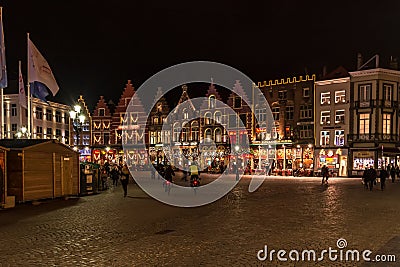 People on the large Market Square Markt in the centre of Bruges, night scene Editorial Stock Photo