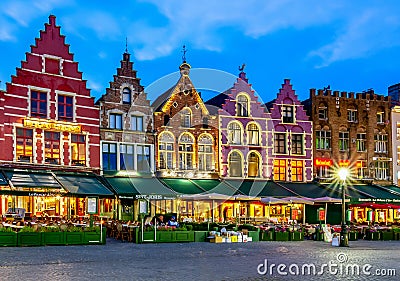 Bruges, Belgium - June 2019: Cafes and restaurants on Brugge market square at night Editorial Stock Photo