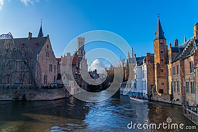 Bruges, Belgium 02/29/2020. Spring scenery with gothic style houses of Sint-Janshospitaal and water canal in medieval belgian city Editorial Stock Photo