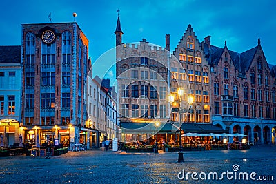 Bruges Grote markt square with cafe and restaurants in the evening night twilight Editorial Stock Photo