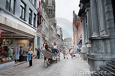 Bruges, Street with typical horse cart Editorial Stock Photo