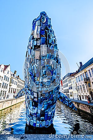 A whale made of 5 tons of plastic waste rises up out of a canal in Bruges, Belgium Editorial Stock Photo