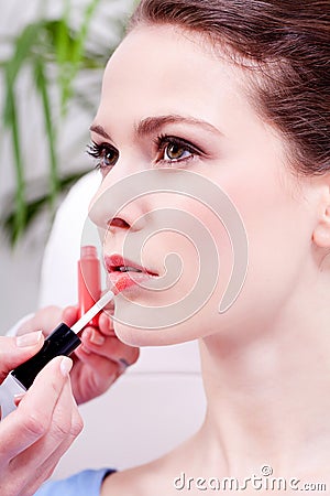 Woman applying lipstick on lips natural beauty Stock Photo