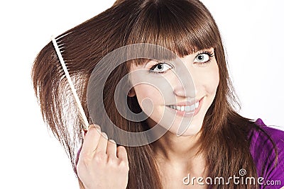 Brunette brushing her hair, in studio Stock Photo