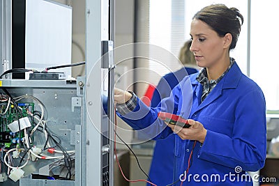 Brunette electrician holding calibrating device Stock Photo